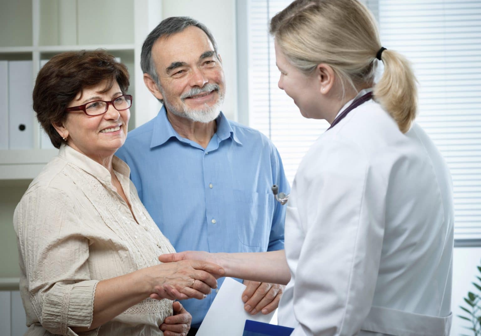 Couple Receiving Hearing Aid Counseling From An Audiologist During a Fitting